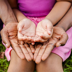 Father holding daughter's hands