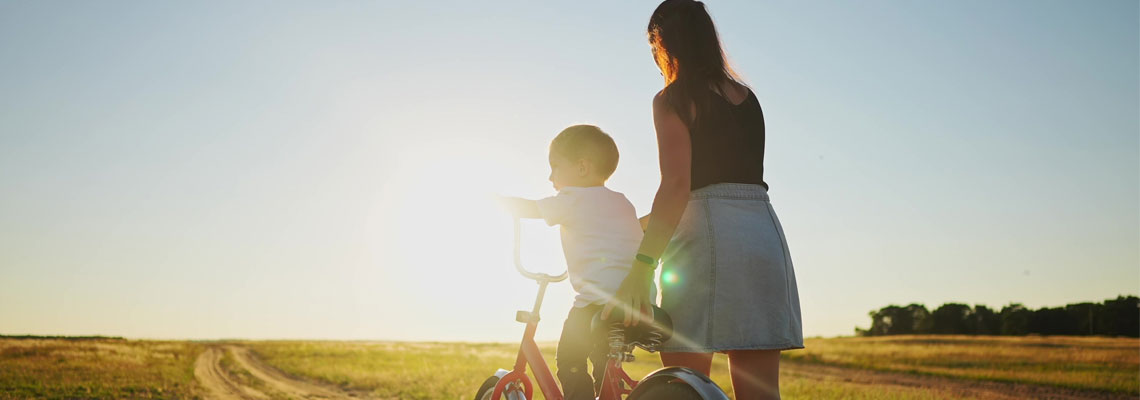 mom teaches son to ride bike