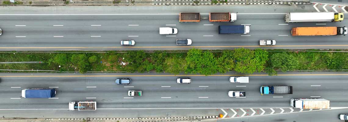 A bird's eye perspective captures multi-lane road with cars