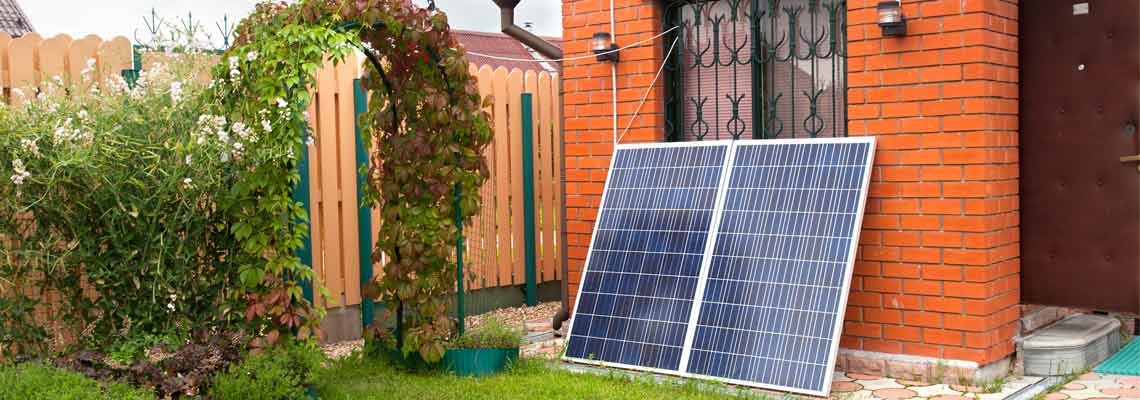 Brick building with balcony-mounted solar panels