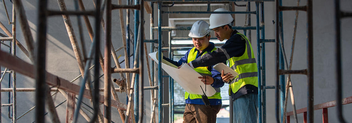 Two construction workers on a building site