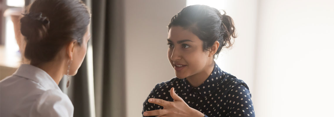 Two women discussing project