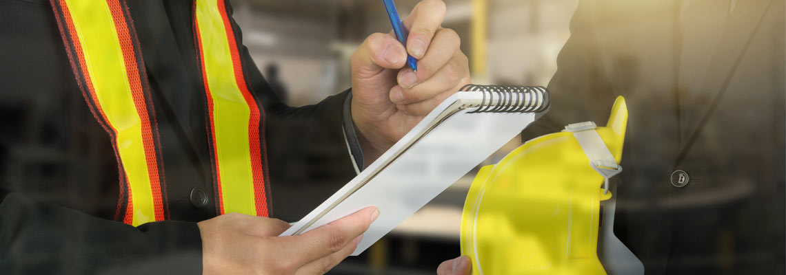 2 male occupational health and safety officers inside factory doing inspection