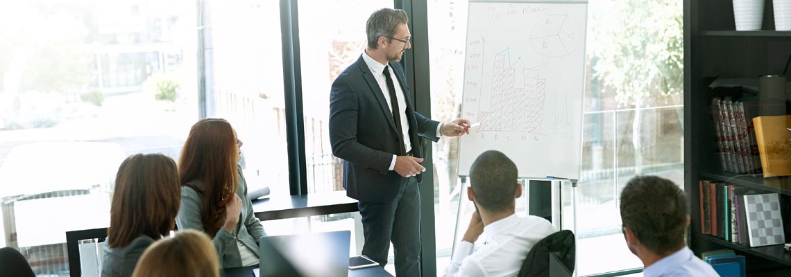 Business people presenting with whiteboard in office