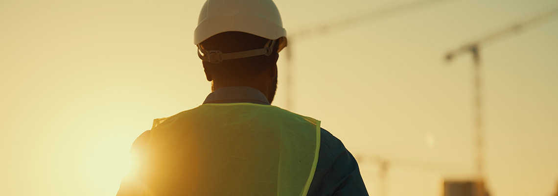 Back view of builder in the sun