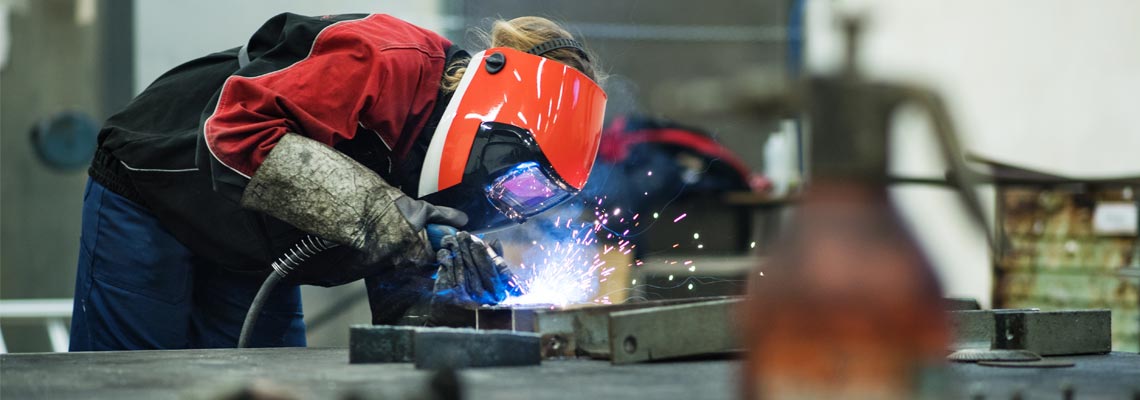 woman working as a welder in workshop