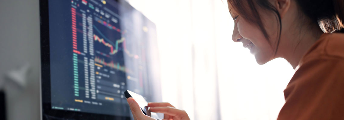 Woman checking Bitcoin price chart on smartphone