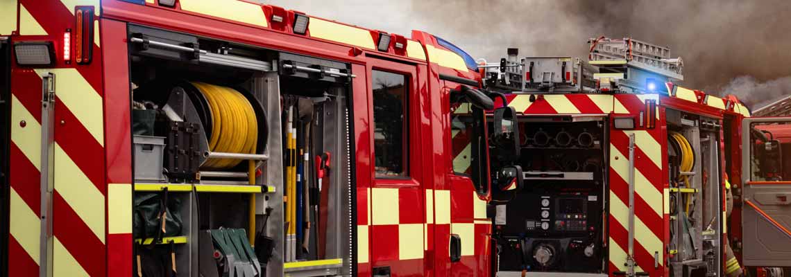 fire engines with firefighting equipment at scene of incident