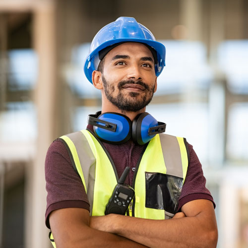 construction site manager wearing safety vest and helmet
