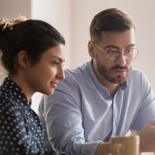 businessman looking at working with a young female