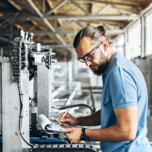 Young engineer manager with beard checking equipment