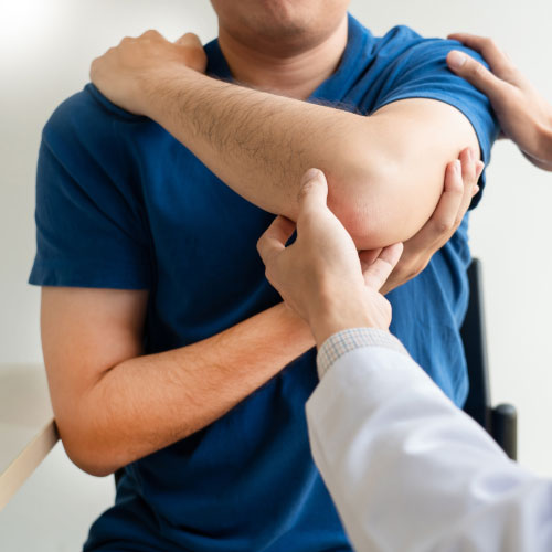 Chiropractor examining from shoulder pain in clinic medical office