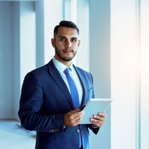 real estate agent stands near big window in new apartment