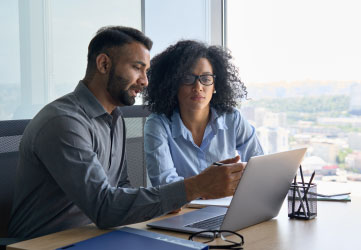 Two corporate professionals working together in office.
