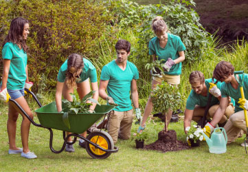 Happy friends gardening for the community on a sunny day