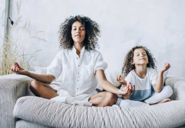 Mother and daughter doing yoga