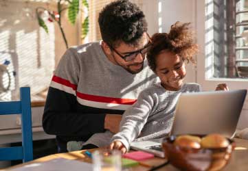 Father and daughter working on the computer