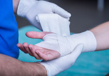 doctor bandaging a hand