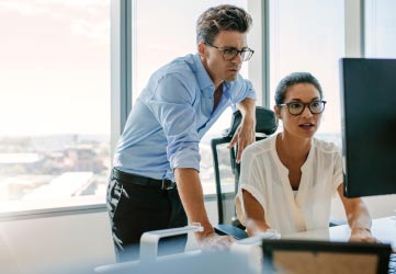 Two corporate professionals working together in office.