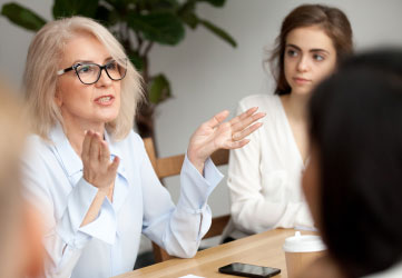 female business leader speaker talking at meeting