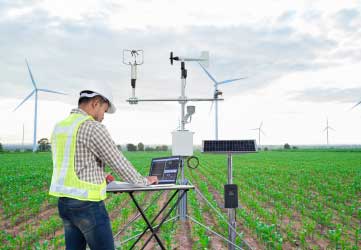 Engineer using tablet computer collect data with meteorological instrument
