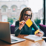 young woman reading books and taking notes