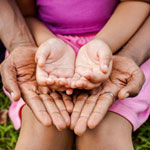 father holding daughter's hands