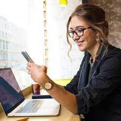 Young woman reading news on her mobile
