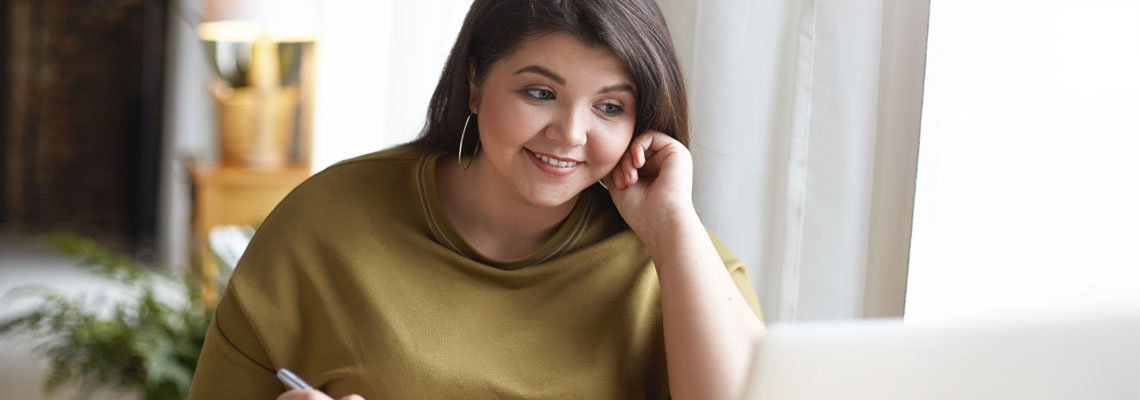 Young woman using laptop in her home