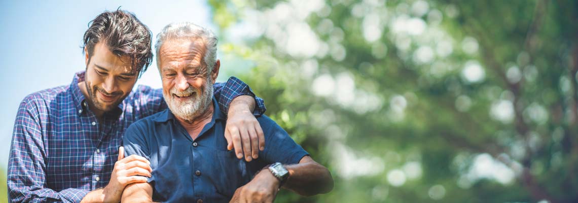 son hugging old senior father