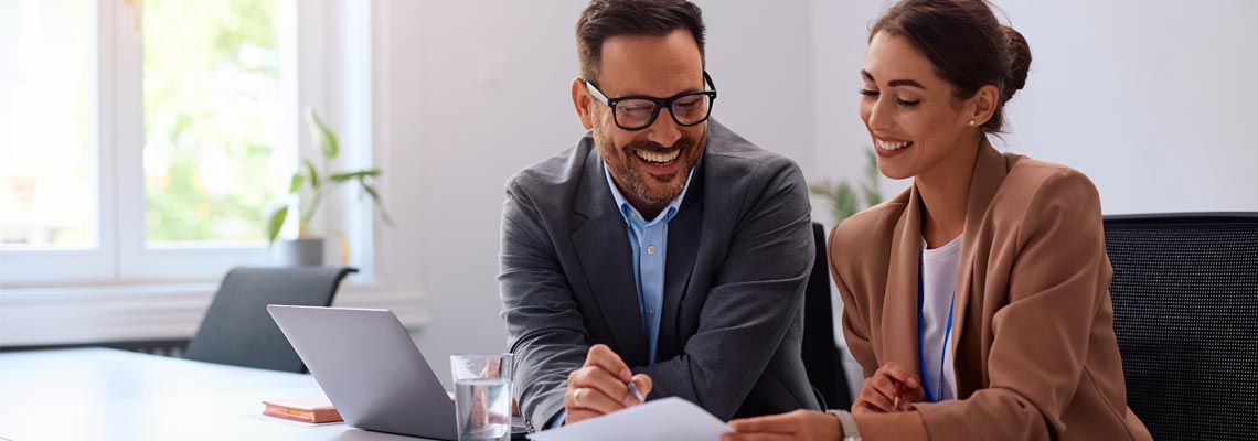Happy businesspeople documents in the office. 