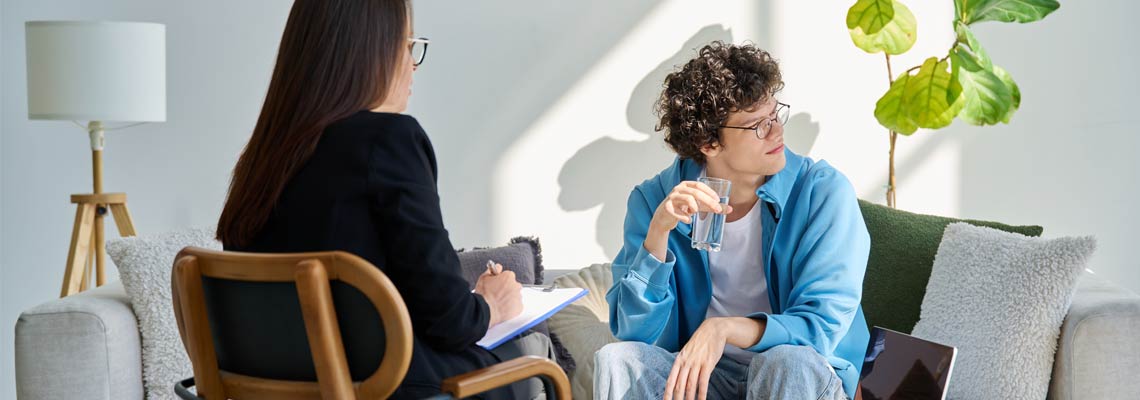 Young man in mental session talking with psychologist