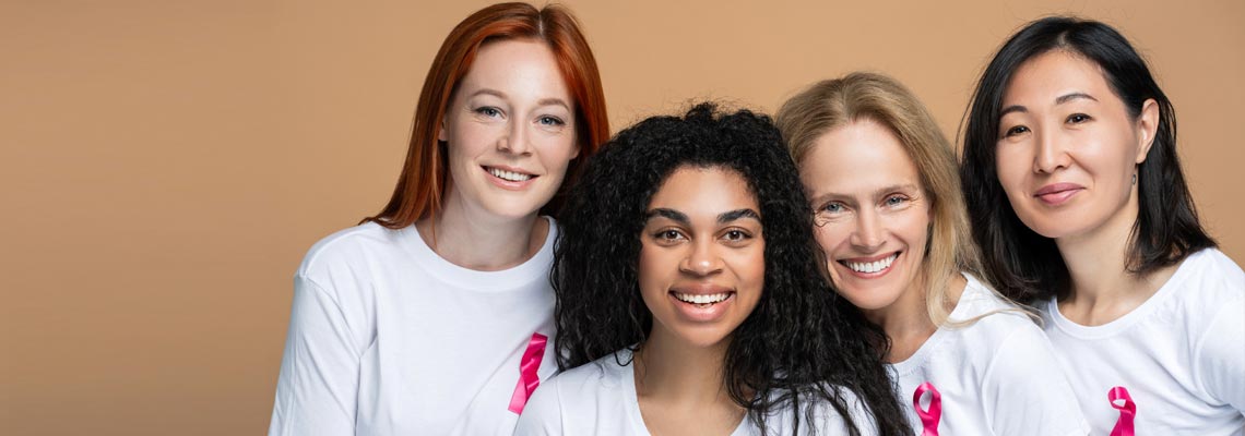 Portrait of smiling group of women with pink ribbons