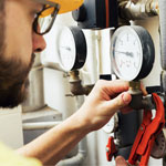 plumber installing pressure meter