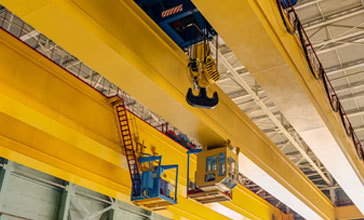 factory overhead crane on a yellow beam