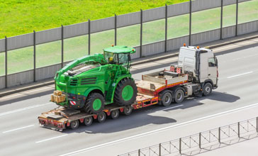 Transportation of agricultural machinery harvester on a trailer