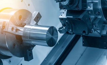 The CNC lathe machine cutting the steel rod