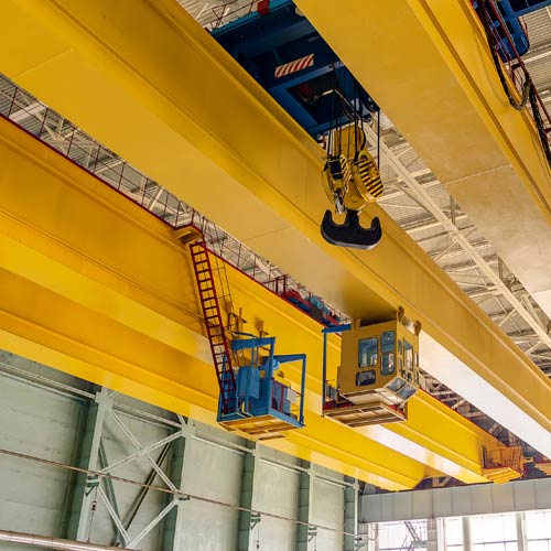 factory overhead crane on a yellow beam