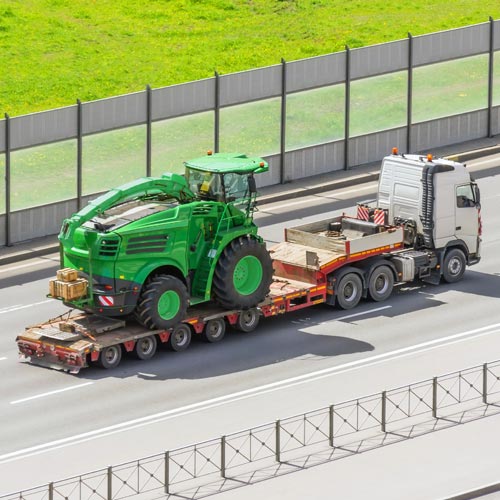 Transportation of agricultural machinery harvester on a trailer