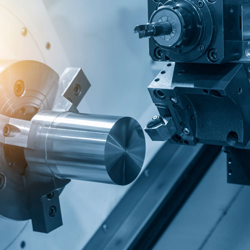 The CNC lathe machine cutting the steel rod