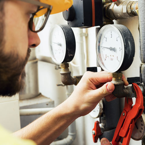 plumber installing pressure meter