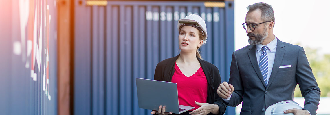 Businesspeople on site with hard hats