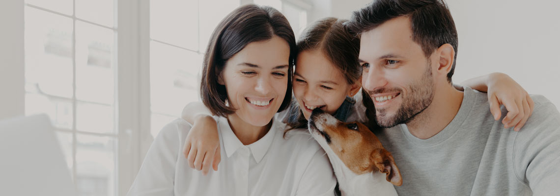  daughter embraces her mother and father, plays with pedigree dog