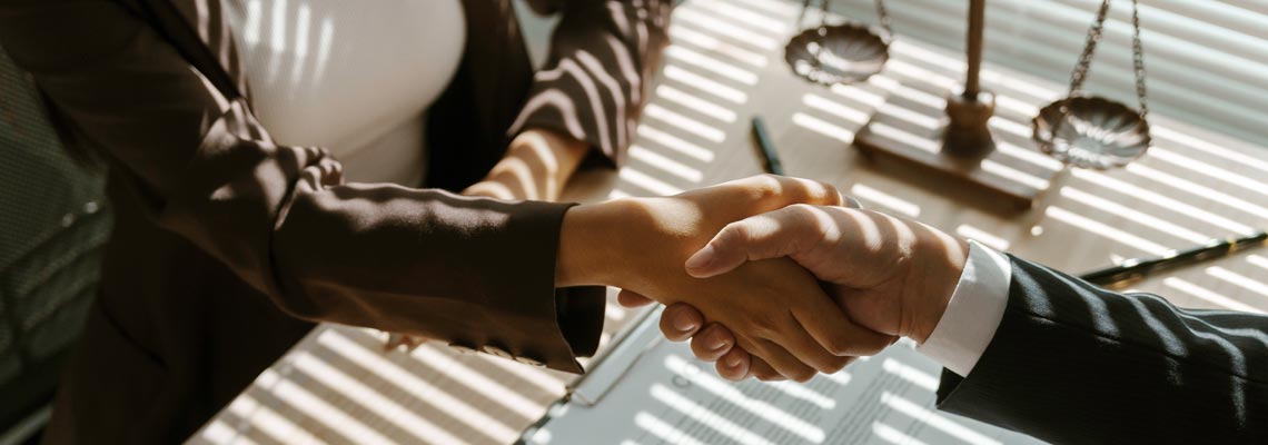 Lawyers shaking hands in a law office