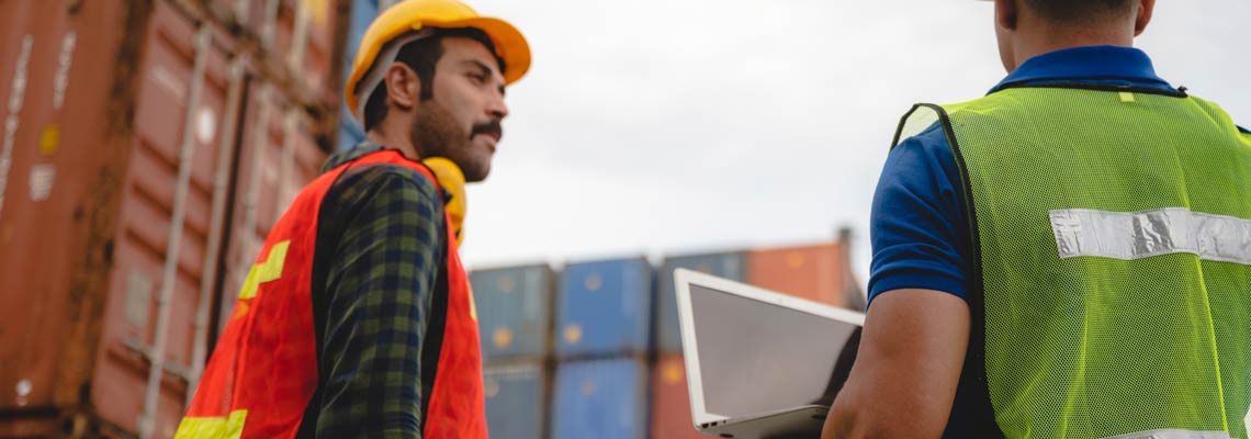 two workers working at logistic industrial transport shipping containers