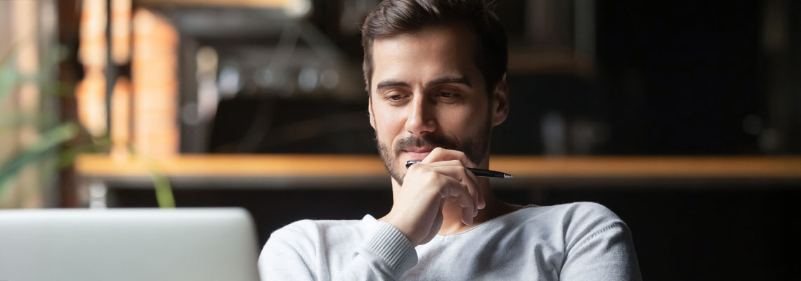 young man looking at laptop screen
