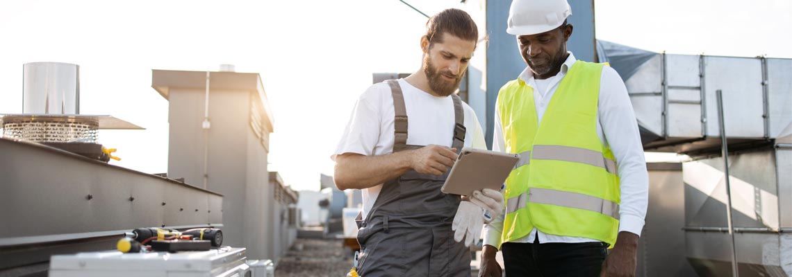repairman looking for information about air conditioners on plant
