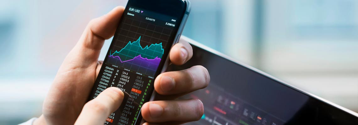 Businessman checking stock market on his mobile