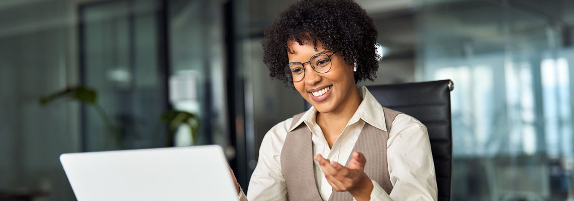 smiling business woman using laptop in the office