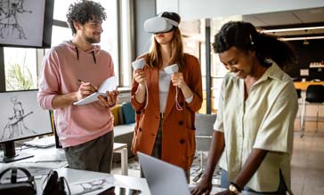 Group of university students in the office using VR simulator headset